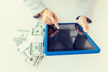 Image showing close up of woman hands with tablet pc and money