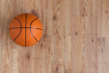 Image showing close up of basketball ball on wooden floor
