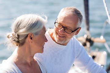 Image showing senior couple hugging on sail boat or yacht in sea