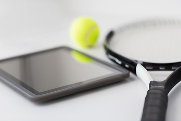 Image showing close up of tennis racket with ball and tablet pc