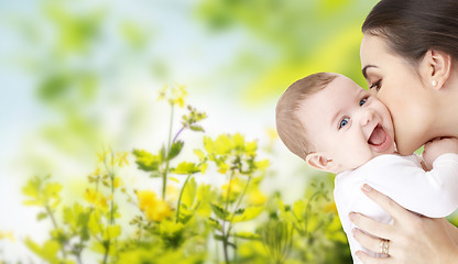 Image showing happy mother kissing adorable baby