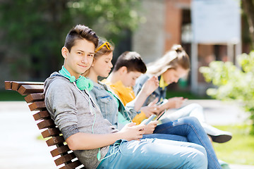 Image showing happy teenage boy with tablet pc and headphones