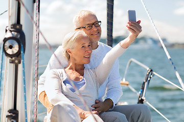 Image showing senior couple taking selfie on sail boat or yacht