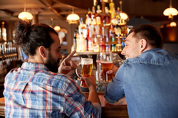 Image showing happy male friends drinking beer at bar or pub