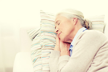 Image showing happy senior woman sleeping on pillow at home