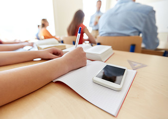 Image showing student with smartphone and notebook at school