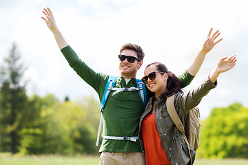 Image showing happy couple with backpacks hiking outdoors