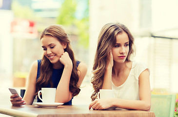 Image showing women with smartphones and coffee at outdoor cafe