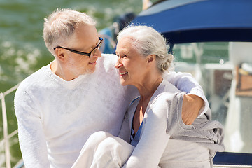 Image showing senior couple hugging on sail boat or yacht in sea