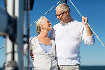 Image showing senior couple hugging on sail boat or yacht in sea