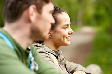 Image showing smiling couple with backpacks in nature