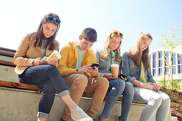 Image showing teenage friends with smartphone and coffee cups