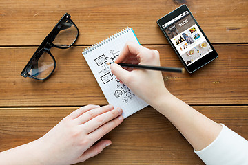 Image showing close up of woman or student writing to notepad