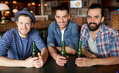 Image showing happy male friends drinking beer at bar or pub