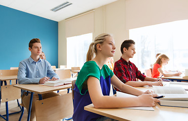 Image showing group of students with books at school lesson