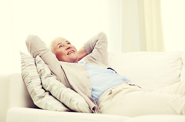 Image showing happy senior woman resting on sofa at home