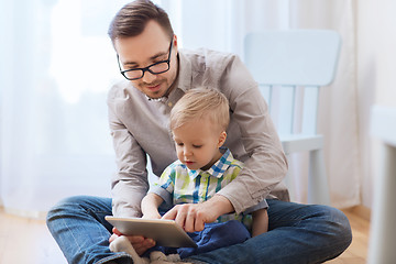 Image showing father and son with tablet pc playing at home