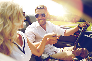 Image showing happy man and woman driving in cabriolet car