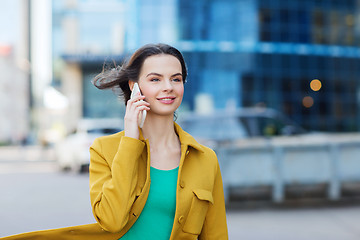 Image showing smiling young woman or girl calling on smartphone