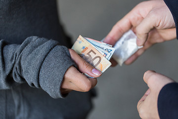 Image showing close up of addict buying dose from drug dealer