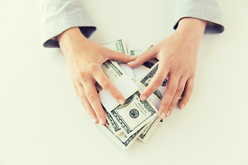 Image showing close up of woman hands counting us dollar money