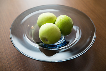 Image showing close up of green apples on glass plate