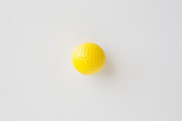 Image showing close up of yellow golf ball over white background