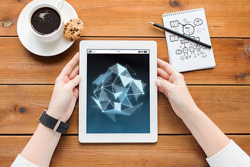 Image showing close up of woman with tablet pc on wooden table