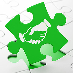 Image showing Business concept: Handshake on puzzle background