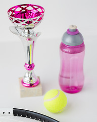 Image showing close up of tennis racket, ball, cup and bottle