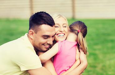 Image showing happy family hugging outdoors