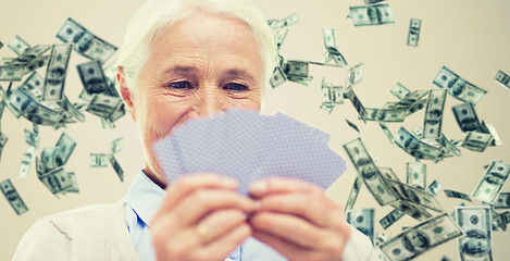 Image showing close up of happy senior woman playing cards