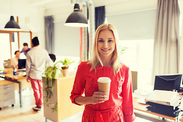 Image showing happy creative woman with coffee cup at office