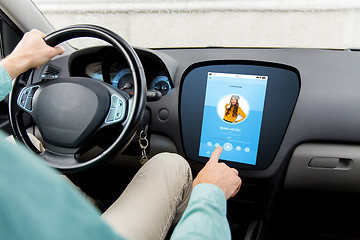 Image showing man driving car with music on board computer