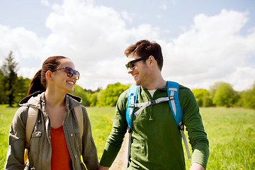 Image showing happy couple with backpacks hiking outdoors