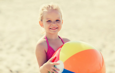 Image showing happy little girl playing inflatable ball on beach