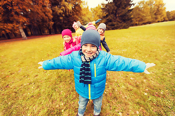Image showing happy little children playing planes outdoors