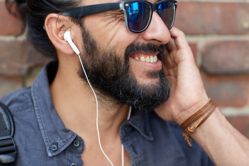 Image showing man with earphones listening to music outdoors