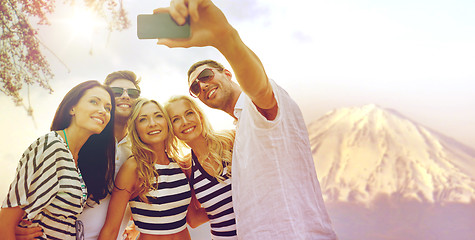 Image showing happy friends taking selfie by smartphone in japan