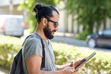 Image showing man traveling with backpack and tablet pc in city