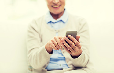 Image showing close up of senior woman with smartphone texting