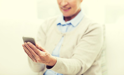 Image showing close up of senior woman with smartphone texting