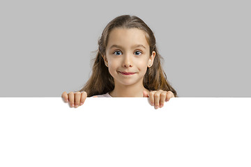 Image showing Cute girl holding a blankboard