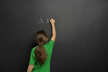 Image showing Girl writing in a blackboard