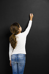 Image showing Girl writing in a blackboard