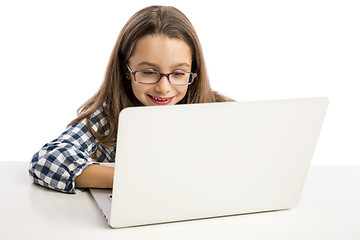 Image showing Little girl working with a laptop