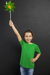 Image showing Little girl holding a windmill