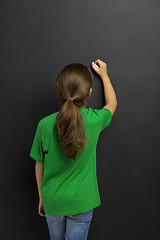 Image showing Girl writing in a blackboard