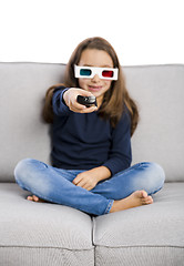 Image showing Girl holding a TV remote