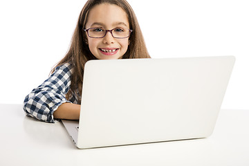 Image showing Little girl working with a laptop